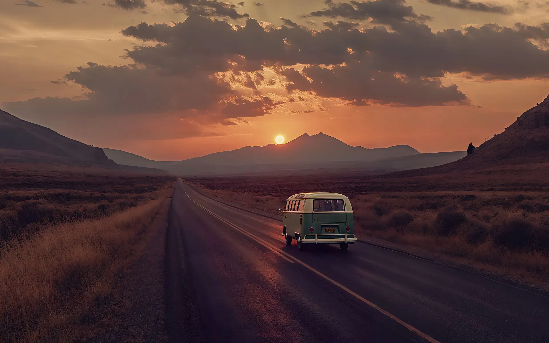 Vintage Camper Van Driving Toward a Mountain Sunset Wallpaper