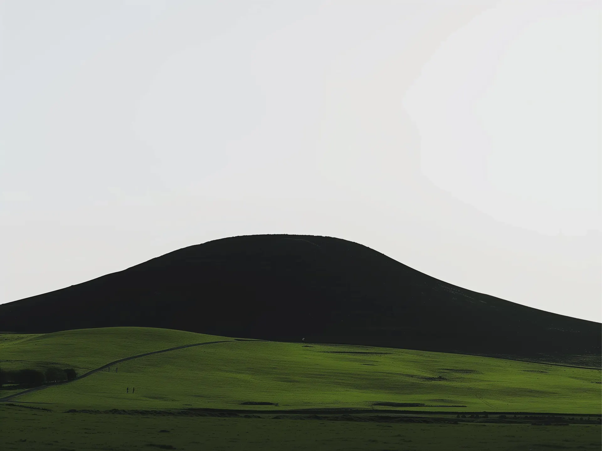 Minimalist Black Mountain and Green Fields Wallpaper