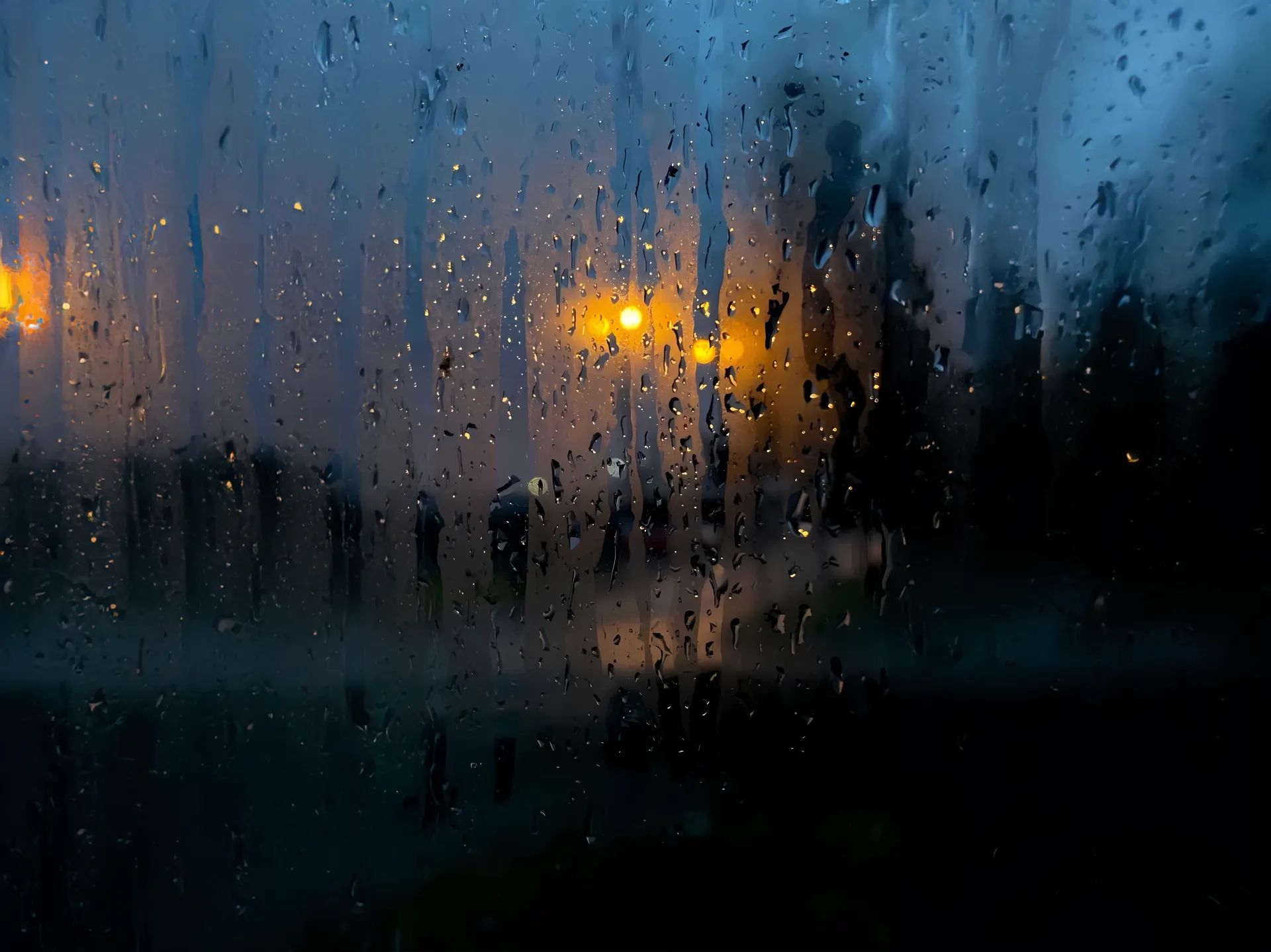 Rainy City Lights Through Foggy Window Wallpaper