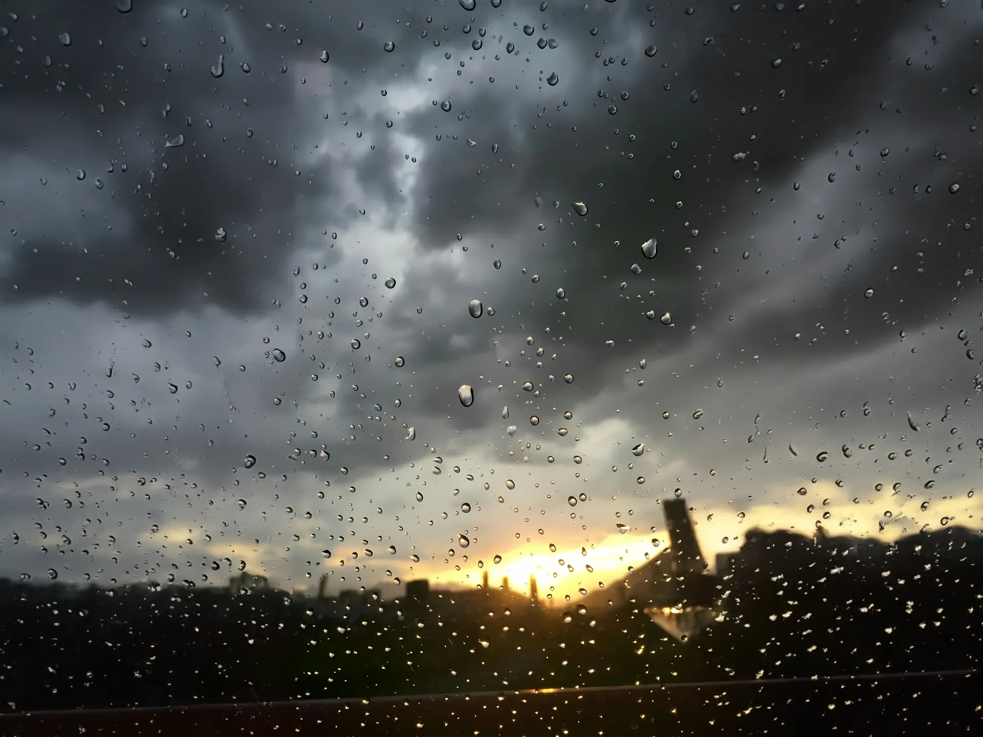 Raindrops and Stormy Sunset City Wallpaper