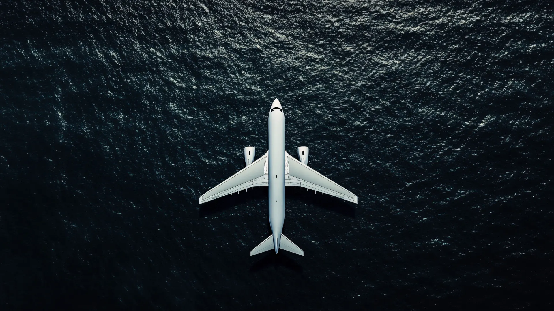 White Airplane Flying Over Dark Ocean Wallpaper