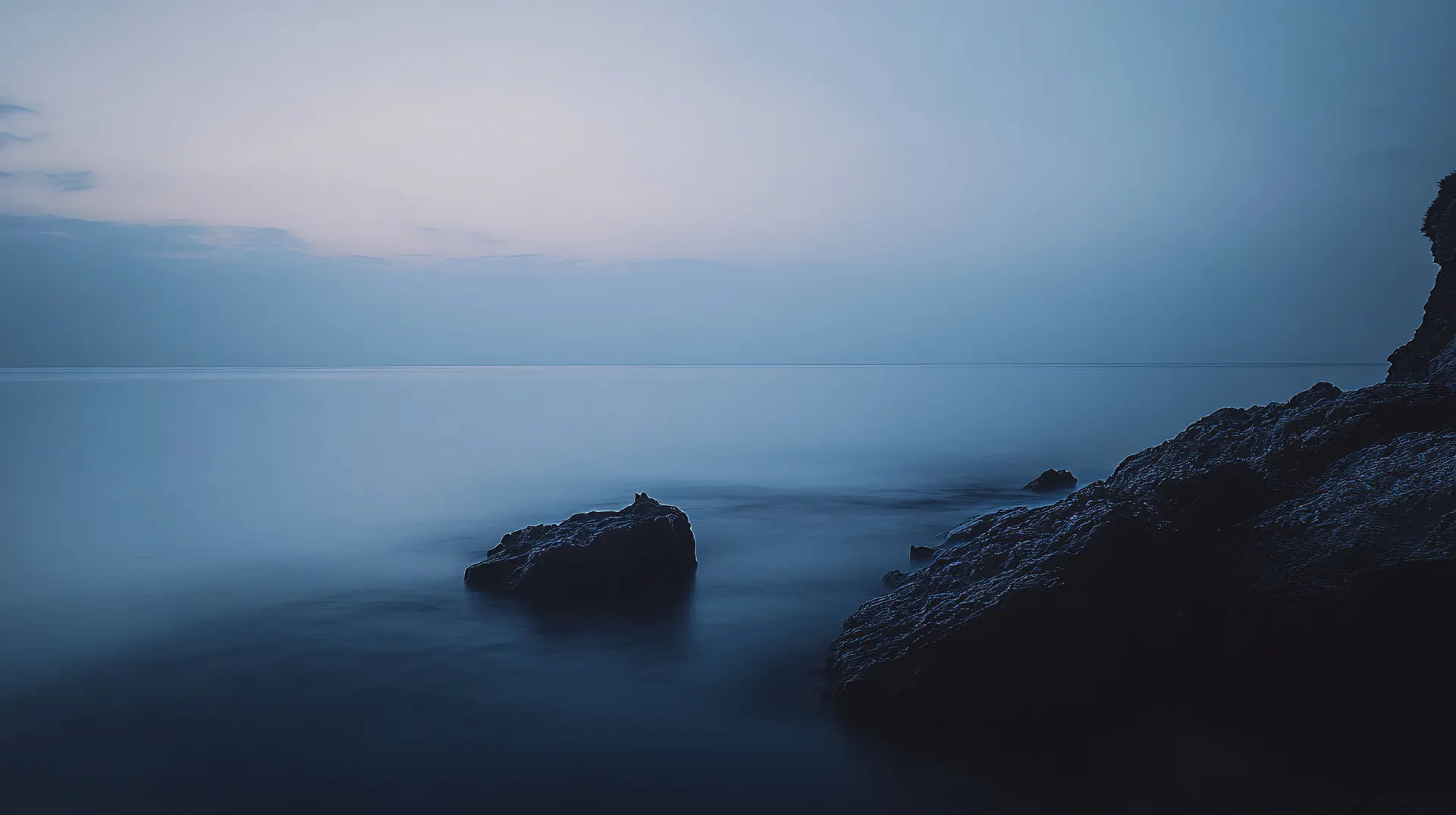 Tranquil Blue Ocean and Rocky Coast Wallpaper