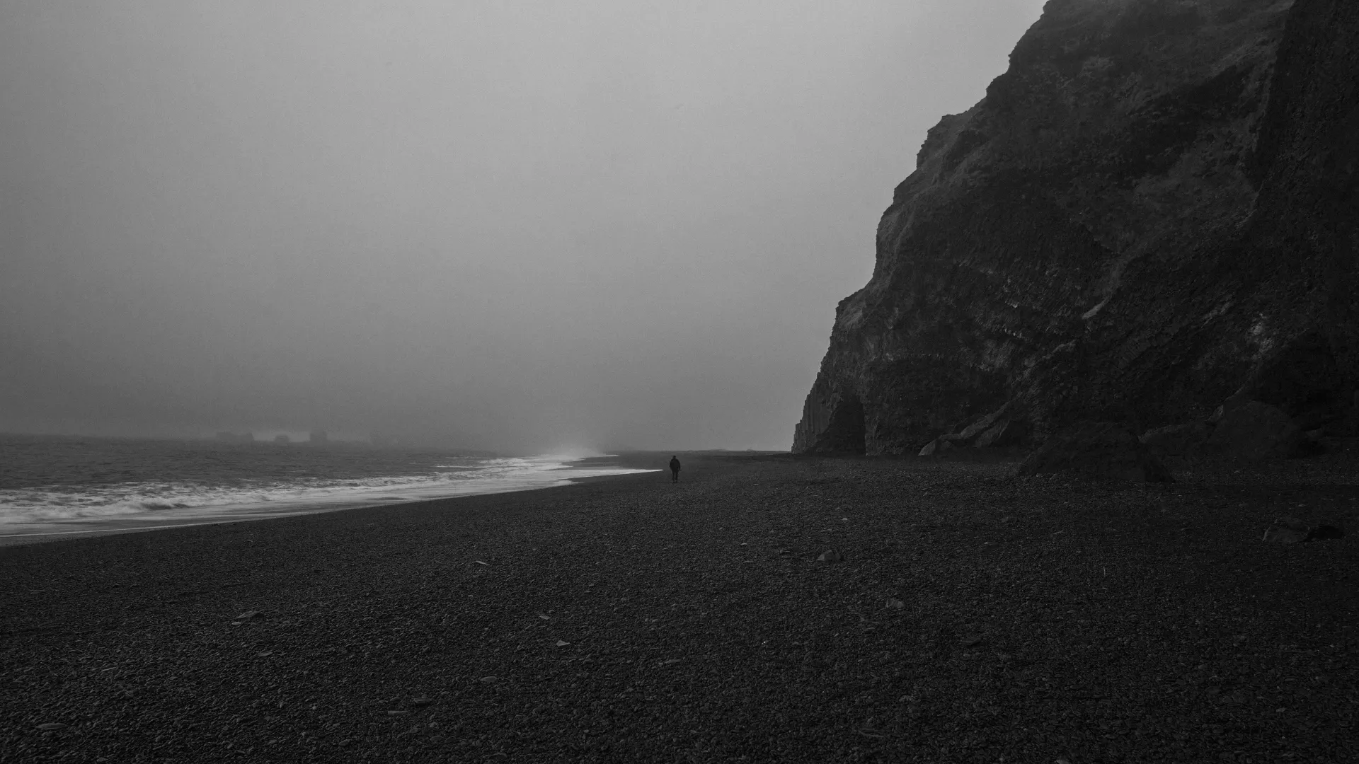 Dark Misty Beach and Rocky Cliffs Wallpaper