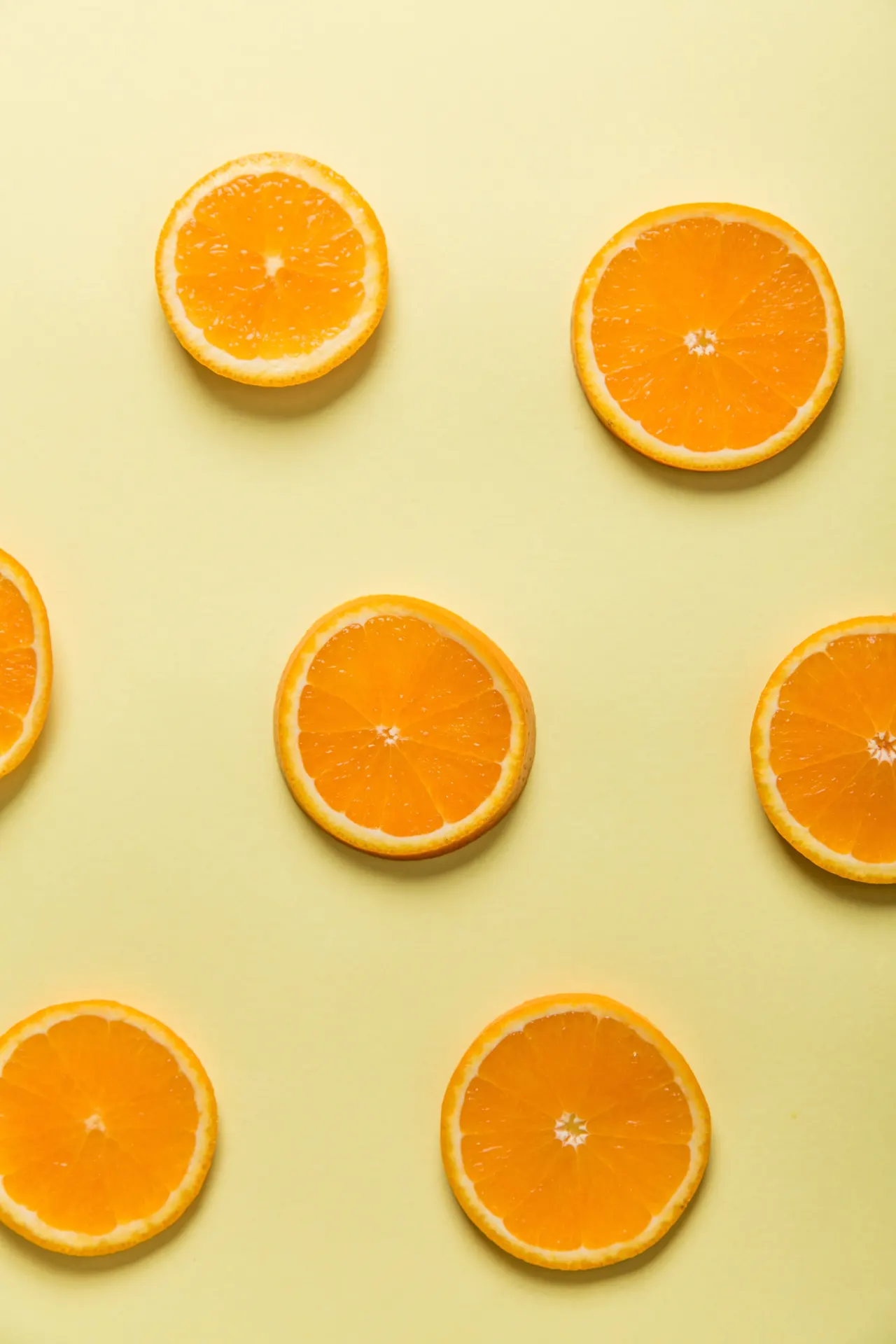 Fresh Orange Slices Yellow Background Wallpaper