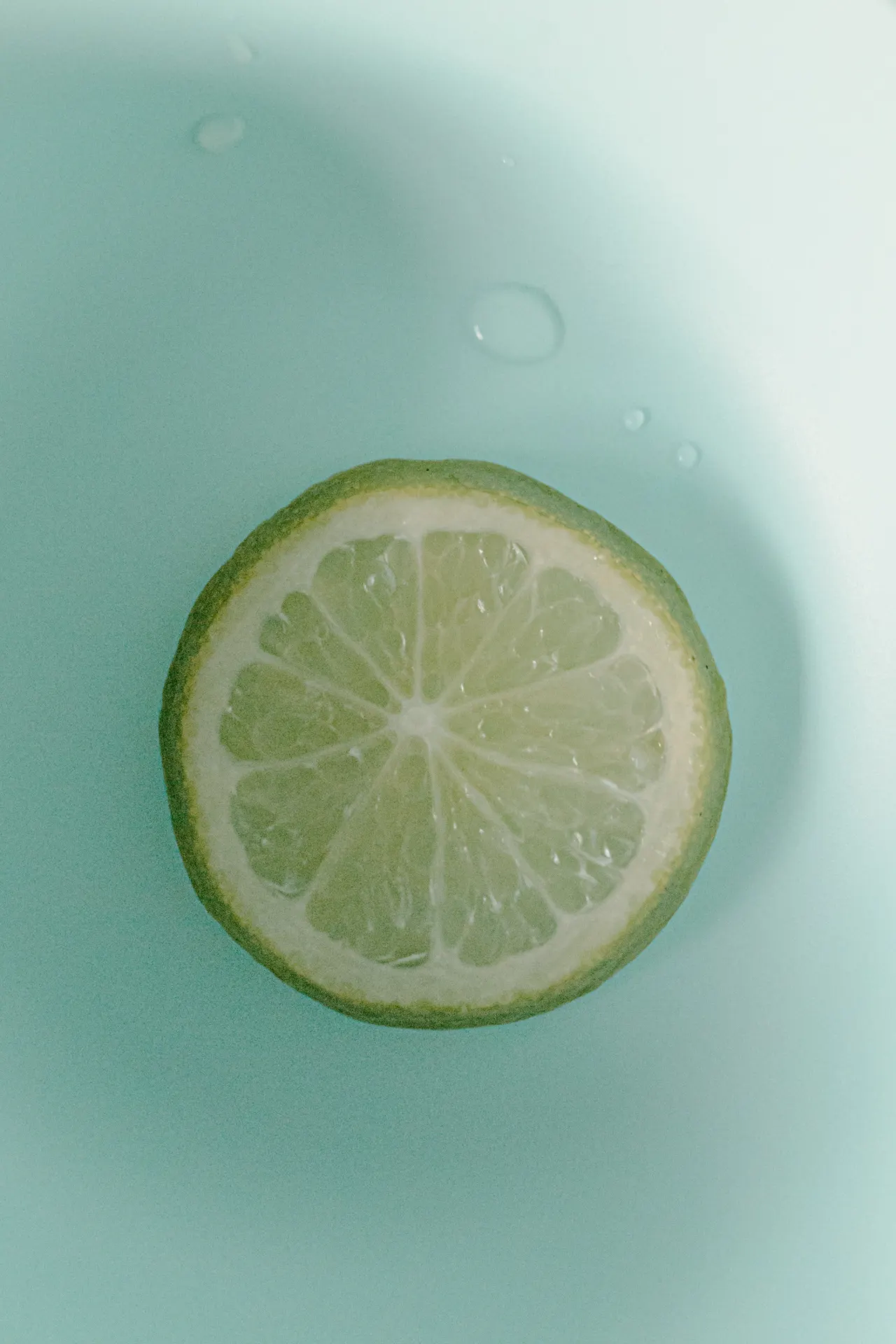 Minimal Lime Slice on Aqua Background Wallpaper