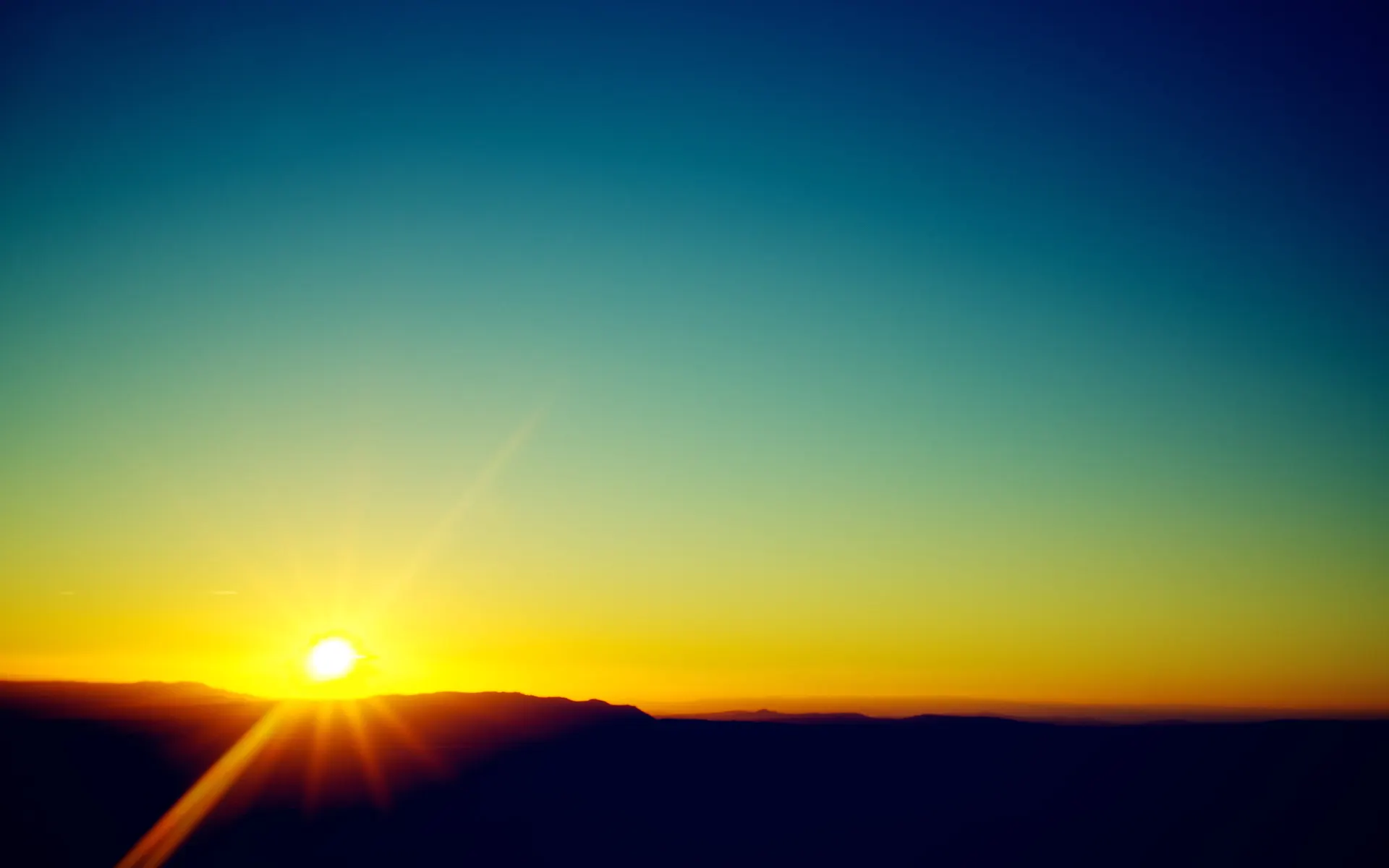 Vibrant Sunrise and Mountain Silhouette Wallpaper